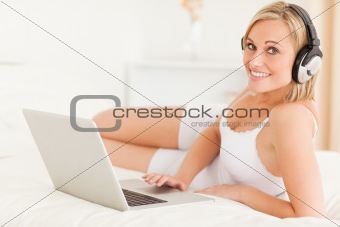 Woman watching movie lying on her bed