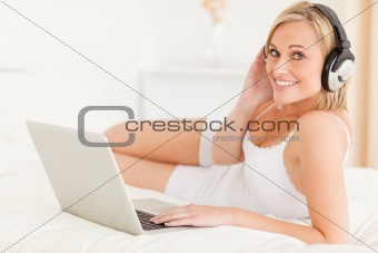 Woman watching movie while lying on her bed