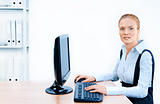Woman works at the computer. Screen has a clipping path.