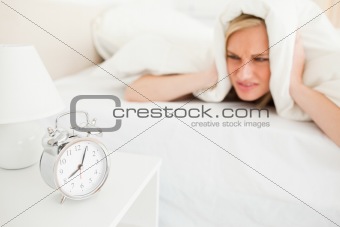 Displeased cute woman waking up