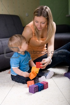 Young mother playing with baby boy 