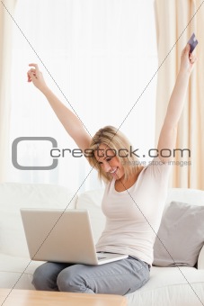 Portrait of a cheerful woman shopping online