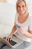 Close up of a smiling woman buying online