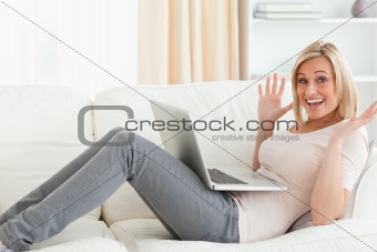 Amazed woman using her laptop