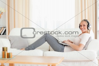 Cute woman with a laptop and headhones