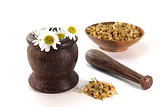 chamomile flowers with mortar