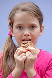 Girl eating chocolate cookies