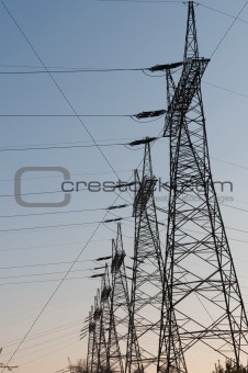 Pylon and transmission power line in sunset