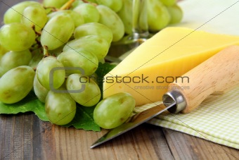 Still-life with grapes white wine  and piece of cheese