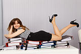 Girl comfortably lay down on documents