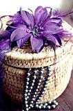 Rattan basket with flower and necklet