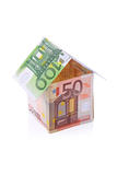 House built with Euro money bills isolated on white background