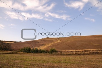 country landscape with a green field and blue sky