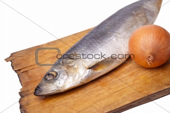 Herring with onion on old kitchen board