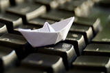 White origami boat on keyboard