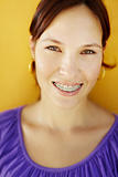 young woman with orthodontic braces smiling
