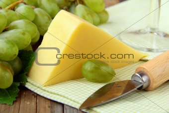 Still-life with grapes white wine  and piece of cheese