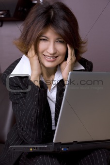 brunette working on laptop