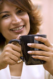 brunette holding cup of coffee