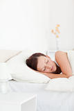 Red-haired woman lying in bed sleeping