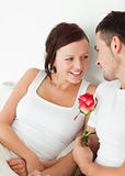 Close up of a Cheerful couple with a rose