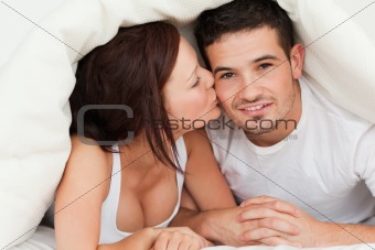Woman kissing man on the cheek
