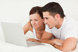 Cheerful couple with a laptop