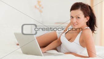 Woman with a laptop looking into the camera