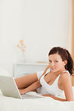 Relaxed woman with a laptop looking into the camera