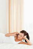 Red-haired Woman phoning on a bed