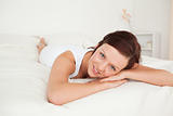 Charming woman relaxing on a bed