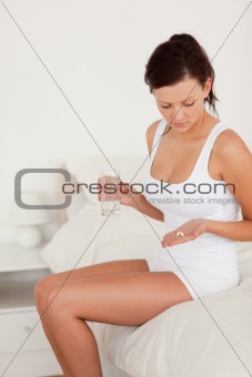 Sick woman holding pills