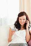 Attractive Woman on the phone holding credit card