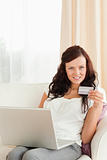 Woman doing online shopping looking at the camera
