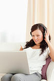 Young woman with headphones and a laptop