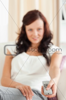 Portrait of a cute woman watching TV