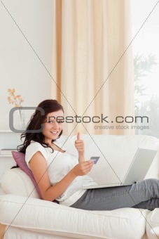 Woman with a laptop and a credit card
