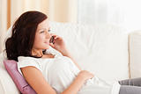 Woman sitting on a sofa with a phone
