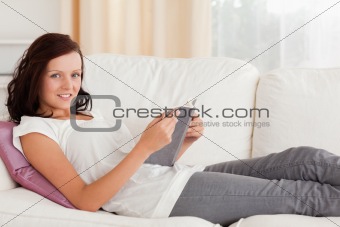 Woman reading a book looking into the camera