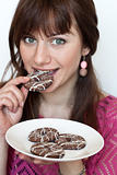 Portrait of a beautiful young brunette with tasty biscuits