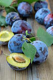 ripe juicy blue plum on a wooden table