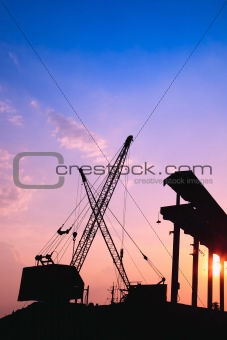 Cranes working at sunset