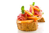 Ham and melon appetizer isolated