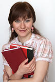 Portrait of a young cute student with textbooks in hand