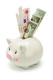 Piggy bank and major world currency notes