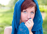 Outdoor Portrait of Pretty Blue Eyed Young Red Haired Adult Female with Blue Scarf.