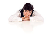 Attractive Smiling Mixed Race Young Adult Female Looking Up and Away Sitting At White Table Resting Her Head on Her Hands Isolated on a White Background.