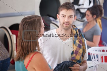 Young Man With Girlfriend In Laundromat