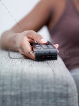 woman holding remote control and watching tv