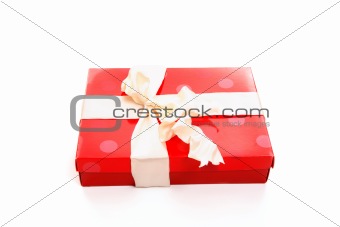 Red box tied with cream ribbon bow